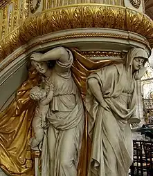 Deux des trois vertus théologales représentées sous la chaire de la cathédrale Notre-Dame d'Amiens. La charité est à gauche de l'illustration.