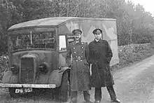Photograph of Cholmondeley and Montagu in uniform, standing in front of a lorry