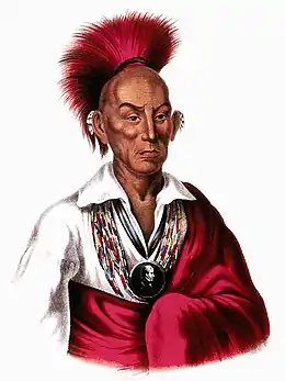 Chef amérindien avec une coiffure rouge et une robe rouge