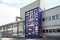 Peinture murale (12 m de hauteur) 2021 par Serge Nidegger au bâtiment de l'administration Villars Maître Chocolatier à Fribourg