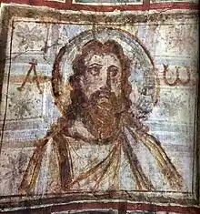 Représentation du visage du Christ, entouré des lettres alpha et oméga