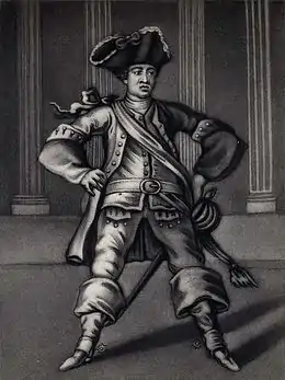 Acteur vu de face, jambes écartées, en tenue militaire, noir et blanc.