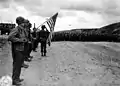 Cimetière provisoire à Vierville, avec la garde au drapeau et le clairon, le 10 juin 1944.