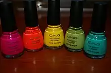 Cinq flacons de vernis à ongles colorés