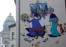 Léonard et son disciple Basile représentés sur un mur de la ville de Bruxelles.