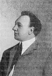Portrait en noir et blanc d'un homme portant un costume.