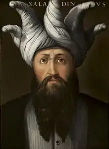 Peinture. Portrait de face. Longue barbe à deux pointes. Spectaculaire turban gris fait de longues torsades dont les pointes partent en vrille de tous les côtés.
