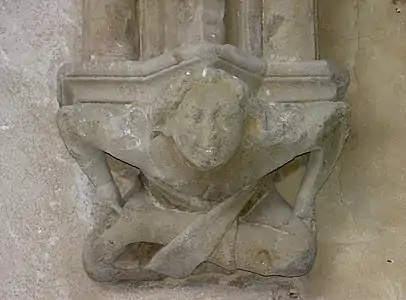 Console d'une des travées de la galerie est de l'abbaye d'Abondance, représentant un petit acrobate souriant, XIVe siècle.