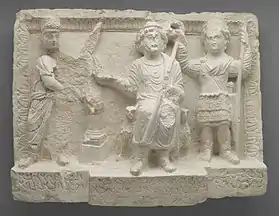Relief de Doura Europos accompagné d’une inscription en palmyrénien : Séleucos Ier couronne le Gad (divinité de la Fortune), accosté de deux aigles et tenant le sceptre