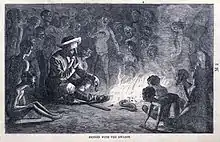 Gravure en noir et blanc d'un européen assis en tailleur près d'un feu et entouré de Pygmées.