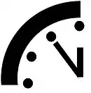 Pictogramme représentant un quart d'horloge, les aiguilles sur minuit mois cinq.