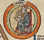 Une miniature représentant le roi assis et couronné, une main pointée vers la gauche et l'autre tenant un sceptre
