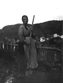 A Canadian gardener at the edge of a Cape Breton Village, 1917