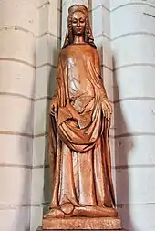 Statue en bois de la Vierge, se tenant debout, les bras écartés, une colombe sur le ventre.