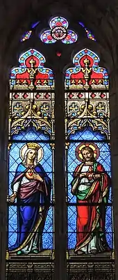 Vitrail coloré en deux parties, montrant à gauche la Vierge Marie, à droite Jésus.