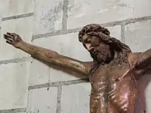 Vue rapprochée sur la tête, le torse et le bras droit du Christ, sans croix.