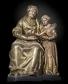 Peinture représentant la Vierge tenant Jésus sur ses genoux, assise à côté de sainte Anne qui lit un livre.