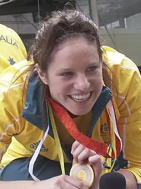Emily Seebohm en train de sourir et de tenir sa médaille d'or olympique en 2008.