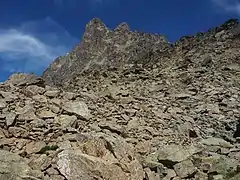 Photographie en couleurs d'une montagne avec de nombreux rochers.