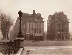 A gauche : la dernière maison du quai de l'Horloge (no 41) faisant angle avec la place du Pont-Neuf (no 12). Photographie par Eugène Atget (1925).