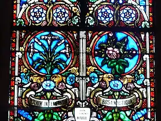 Vitrail de la Rosa mystiqua et du Lys à l'église d'Excideuil (Dordogne).