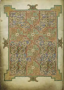 Page tapis couverte d'entrelacs noueux, avec une croix, Évangiles de Lindisfarne.