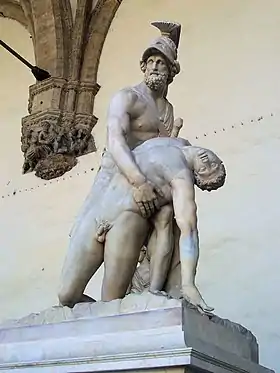 Statue en marbre d'un homme nu, barbu, arborant épée et casque, tenant dans ses bras le corps sans vie d'un homme nu.