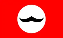 Cercle blanc contenant des moustaches à guidon noires, le tout sur fond rouge.
