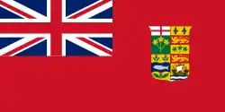 Le red ensign canadien, qui comprend l'Union Jack dans le canton, un fond rouge et les armoiries du Canada au centre.