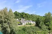 Les maisons du hameau de La Bussière nichées au pied de la falaise.