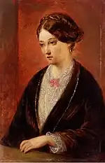 portrait d'une femme, Florence Nightingale, en plan rapproché taille, portant un vêtement marron et blanc, et qui regarde sur le côté.