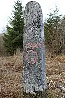 Borne en pierre sculptée de forme menhir.