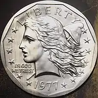 Pièce de monnaie représentant le profil gauche d'un femme aux cheveux longs, treize étoiles, un bonnet phrygien et les inscriptions Liberty, In God We Trust et 1977.