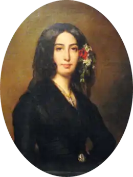 Portrait ovale d'une femme en buste vêtue de noir, les yeux noirs, des cheveux bruns encadrant le visage et mêlés de fleurs