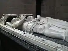 Photographie représentant les gisants en marbre blanc d'Olivier V de Clisson et Marguerite de Rohan, couchées côte à côte, dans la basilique Notre-Dame du Roncier.