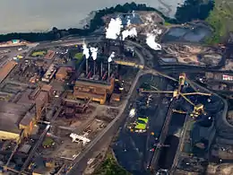 Photo aérienne de l'usine de New Zealand Steel où on distingue 4 tambours.