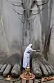Une croyante lavant les pieds de la statue