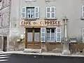 Ancien café du commerce et croix encastrée dans le mur.