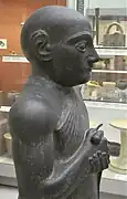 Statue V, détail : haut du corps avec épaule et bras visible, tête recollée. British Museum.