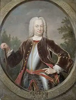 Un portrait du gouverneur général van Imhoff avec une grande perruque blanche et un manteau brun sur des plaques d'armure. Il porte une canne à la main gauche et une épée dans son fourreau sur le côté droit.