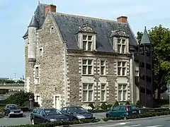  Photographie d'un hôtel particulier, isolé, avec un parking au pied de l'édifice.