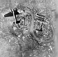 Photomontage de propagande en noir et blanc montrant un bombardier survolant Londres.