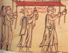 Enlumineure homme couronné portant une couronne portant un objet cylindrique enroulé dans un voile. Quatre hommes tiennent un drap au-dessus du souverain.