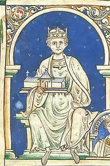 Miniature montrant un roi couronné sur un trône, se détachant sur un fond bleu.