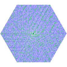 Spirale hexagonale avec les nombres premiers en vert et les nombres avec de nombreux facteurs en bleu foncé.