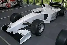 Photo d'une monoplace de Formule 1 blanche dans un musée