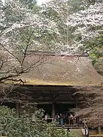 Wooden building with open railed veranda and slightly raised floor.