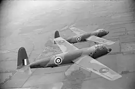 Photographie en noir et blanc de deux avions militaires en plein vol