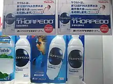 Des bouteilles de boisson portant la marque Torpedo, avec des affiches représentant Thorpe.