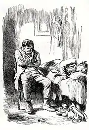 Tassé sur une chaise, bras croisés, un homme plongé dans ses pensées. À droite, un lit où gît un homme soit inconscient soit en train de dormir